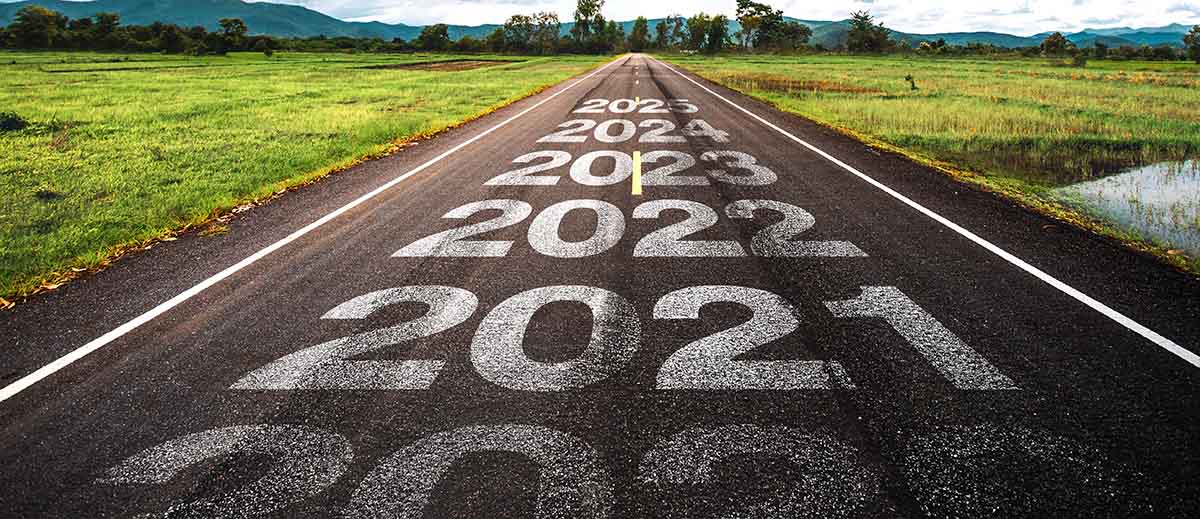 A road with years listed on the pavement and increasing in years as the road continues.